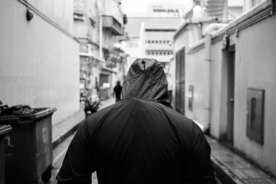 Rear view of man standing in city