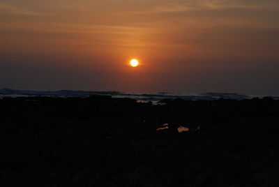 Scenic view of silhouette landscape against romantic sky at sunset