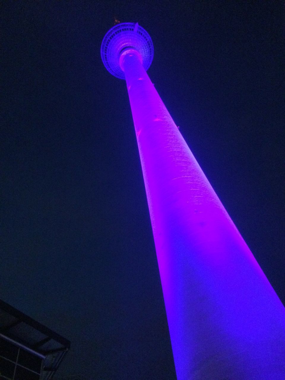 LOW ANGLE VIEW OF ILLUMINATED TOWER AGAINST CLEAR BLUE SKY