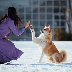 Full length of woman sitting outdoors