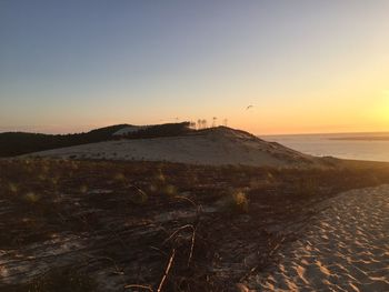 Scenic view of sea against clear sky during sunset