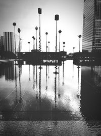 Reflection of buildings on wet river during rainy season