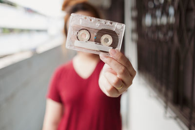 Close-up of woman holding cassette
