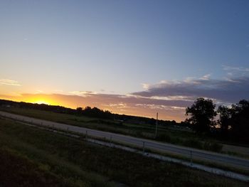 Scenic view of field against sky during sunset