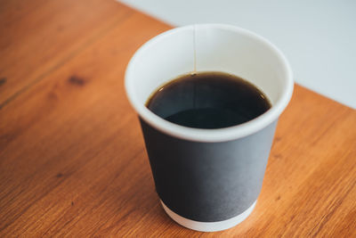 Coffee paper cup in the wooden table.