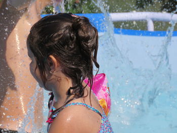 Side view of girl in wading pool