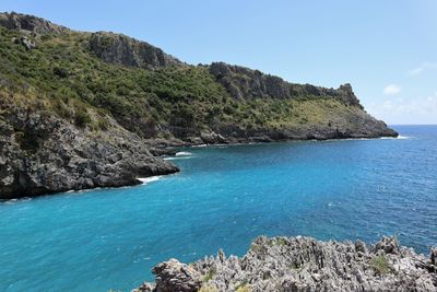 Scenic view of sea and rocks against sky