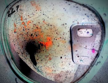 High angle view of water drops on rusty metal