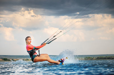 Man surfing in sea against sky