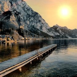 Scenic view of lake against mountains during sunset