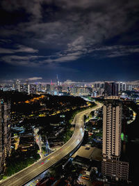 High angle view of illuminated cityscape against sky at night