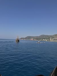 Scenic view of sea against clear blue sky