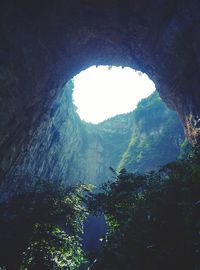 Low angle view of mountain seen through arch