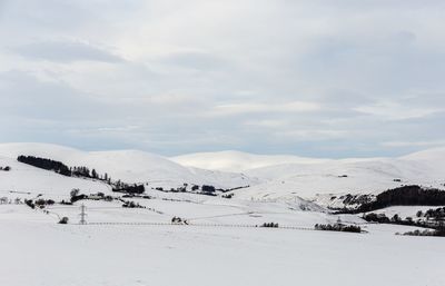 Scenic view of snow covered mountains against sky