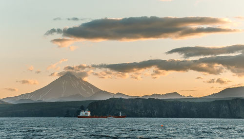 Scenic view of snowcapped mountains against sky during sunset