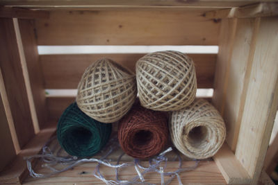 Close-up of thread spools in wooden container