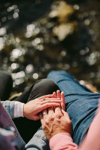 Midsection of couple holding hands