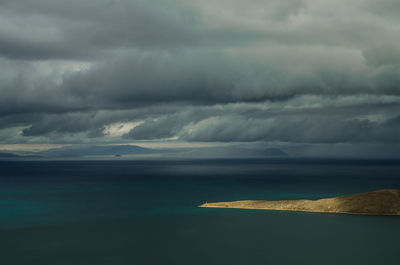 Scenic view of sea against storm clouds