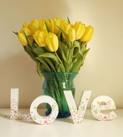 Close-up of yellow tulips in vase on table