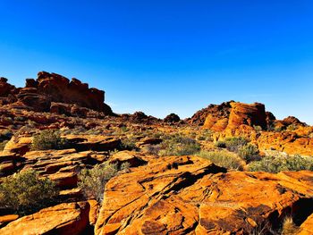 Scenic view of rock formations against clear blue sky