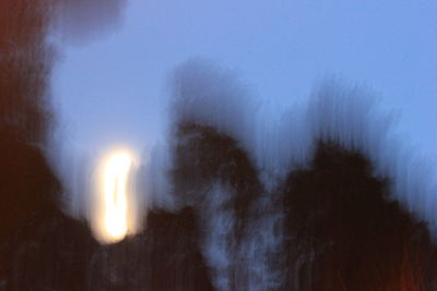 Low angle view of illuminated lighting equipment against sky at night