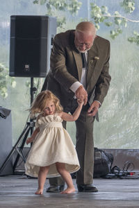 Grandfather dancing with granddaughter