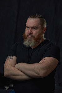 Portrait of senior man with head in darkroom