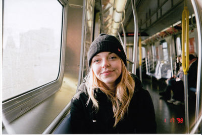 Portrait of smiling mid adult man in train