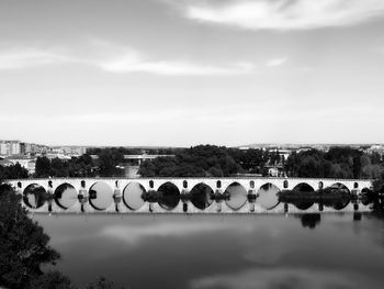 Scenic view of river with bridge against sky