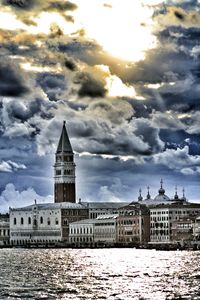 Buildings against cloudy sky