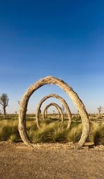 Metallic structure on field against clear sky