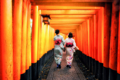 Rear view of people walking in temple