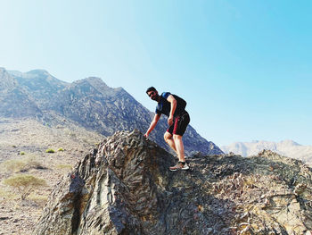 Full length of man on rock against sky