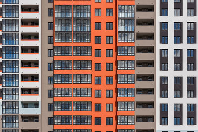 Full frame background of new high rise apartament building wall with multiple balcony and windows