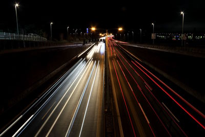 High angle view of light trails on road at night