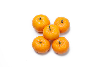 Close-up of orange fruit against white background