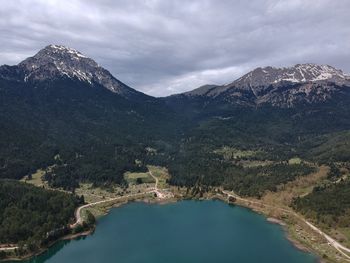 Scenic view of lake and mountains against sky