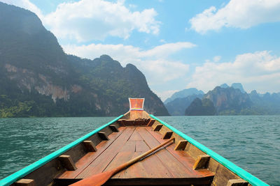 Scenic view of sea and mountains against sky