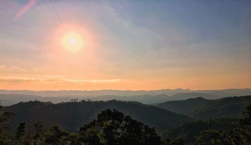 Scenic view of silhouette mountains against sky during sunset