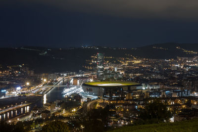 High angle view of illuminated buildings in city at night