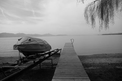 Pier over lake against sky