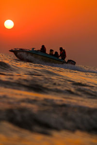 Scenic view of sea against orange sky