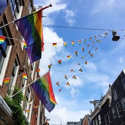 Low angle view of flags hanging against sky