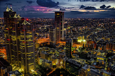 High angle view of illuminated city buildings against sky