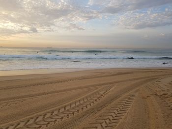 Scenic view of beach against sky during sunset