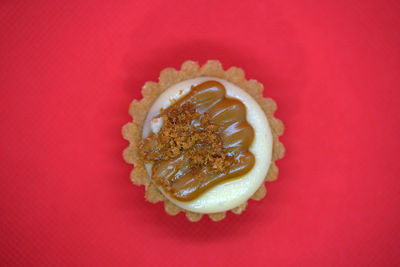 Close-up of cupcakes over red background