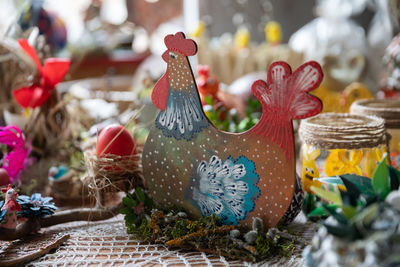 Beautifully painted hen sits in a nest. easter decoration.
