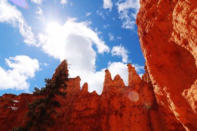 Low angle view of rocks against sky on sunny day