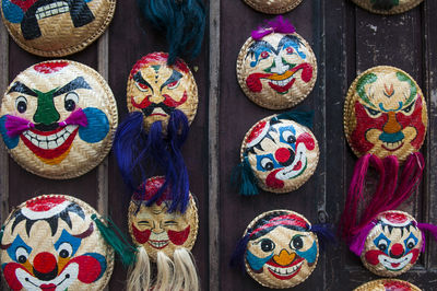 Close-up of wicker masks on display at market stall