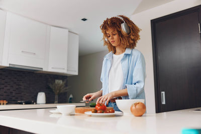 Rear view of young woman working at home